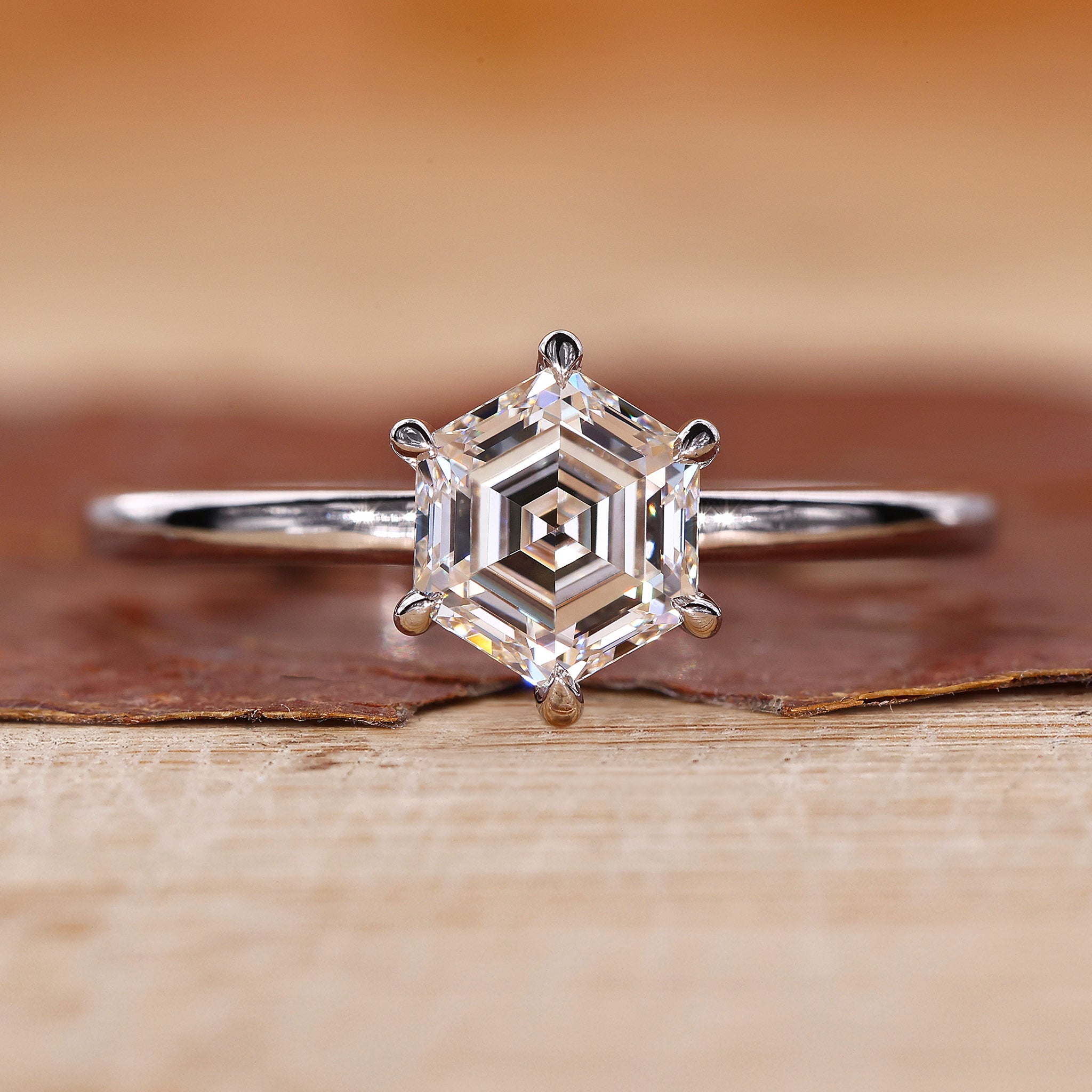 Hexagon step cut diamond shines in the ring.
