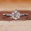 Hexagon step cut diamond shines in the ring.
