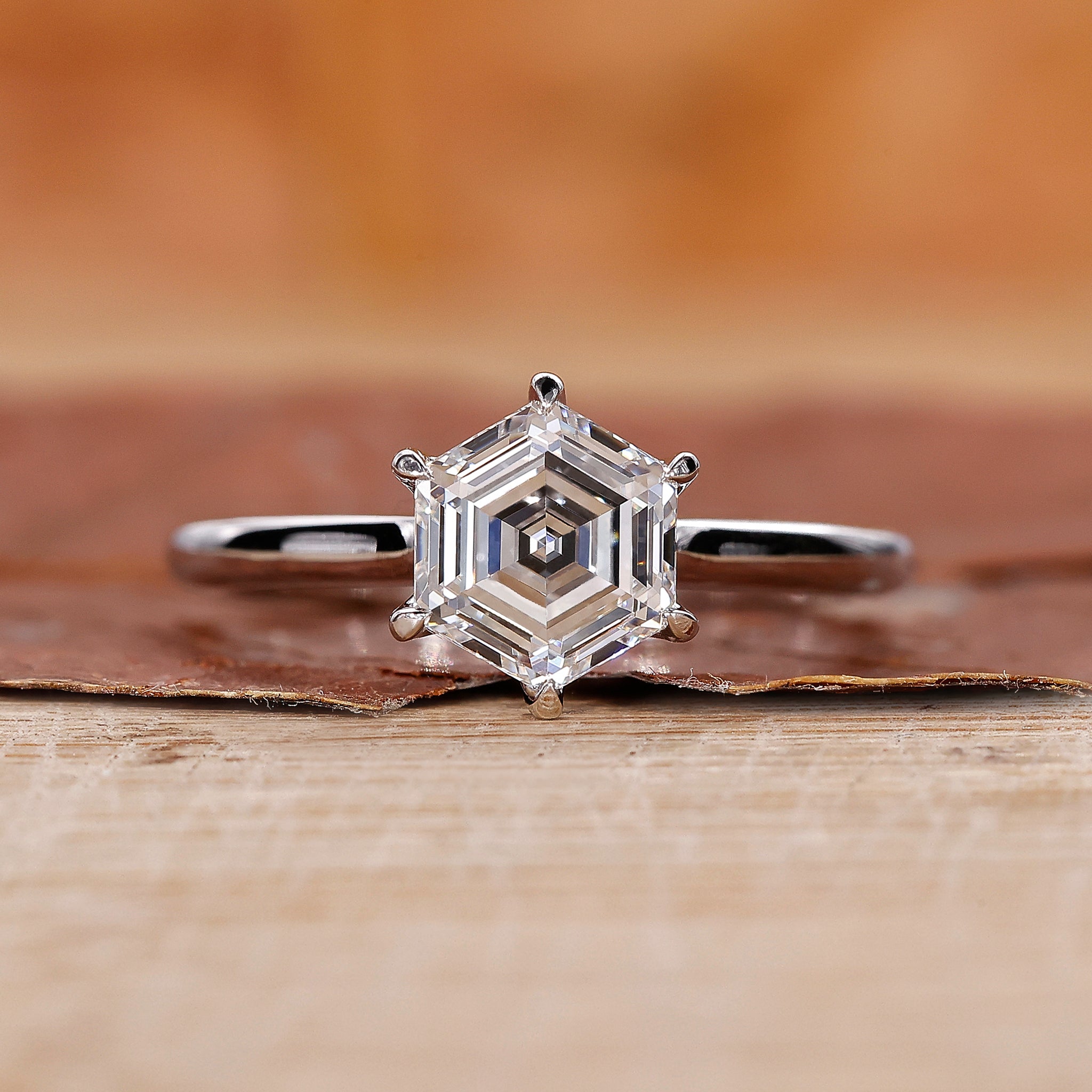 Solitaire engagement ring with a hexagon diamond design.
