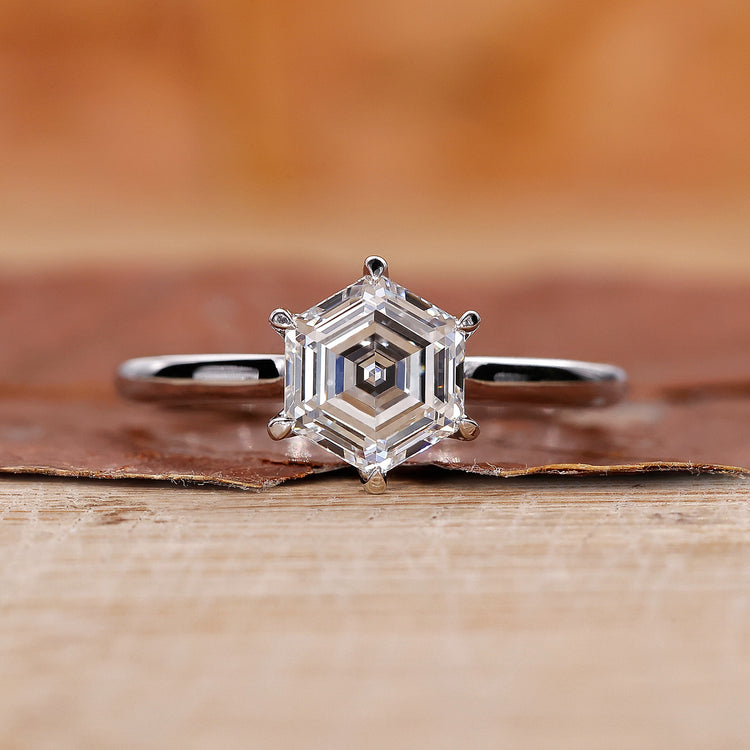 Solitaire engagement ring with a hexagon diamond design.
