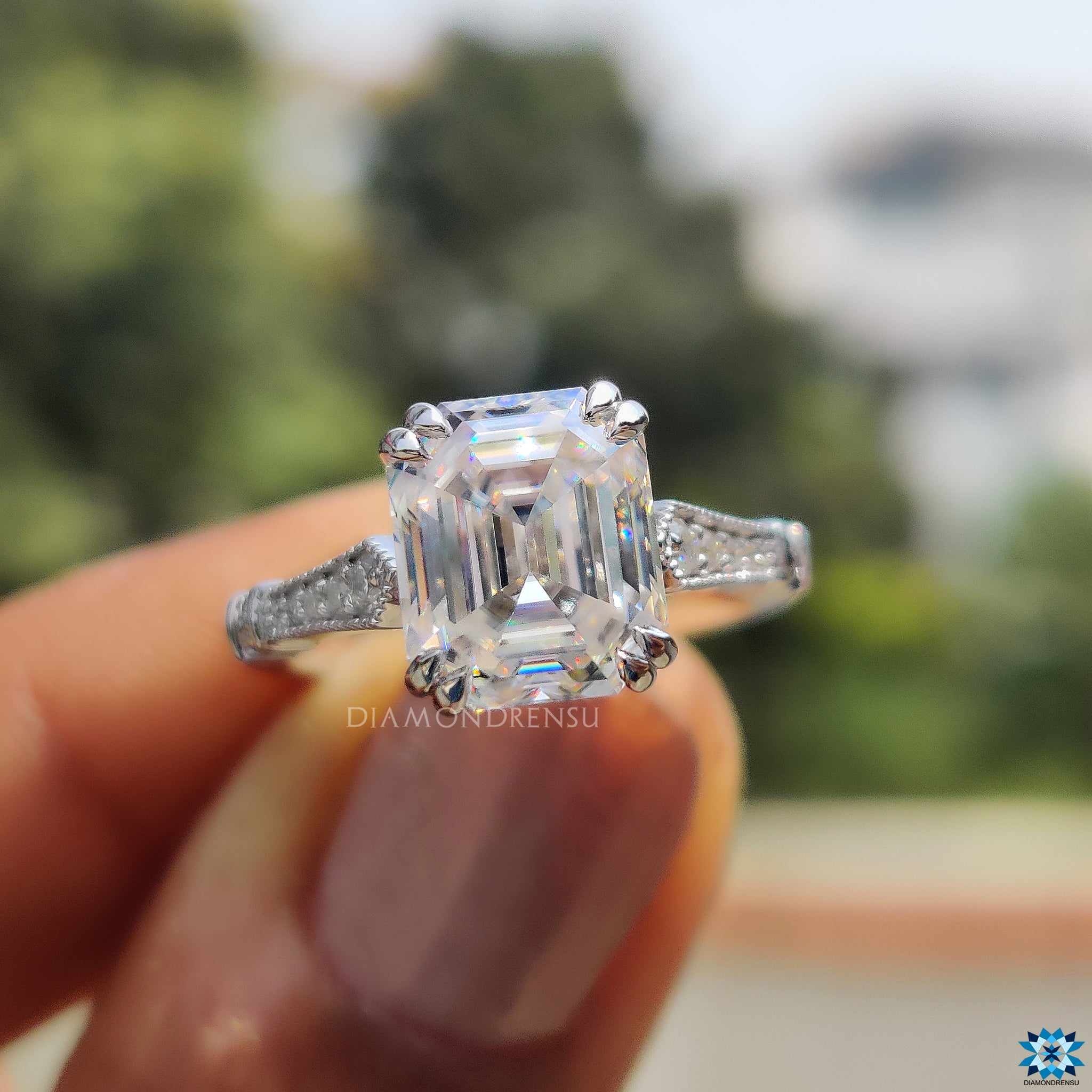 Buy moissanite ring with round side stones and double claw setting.
