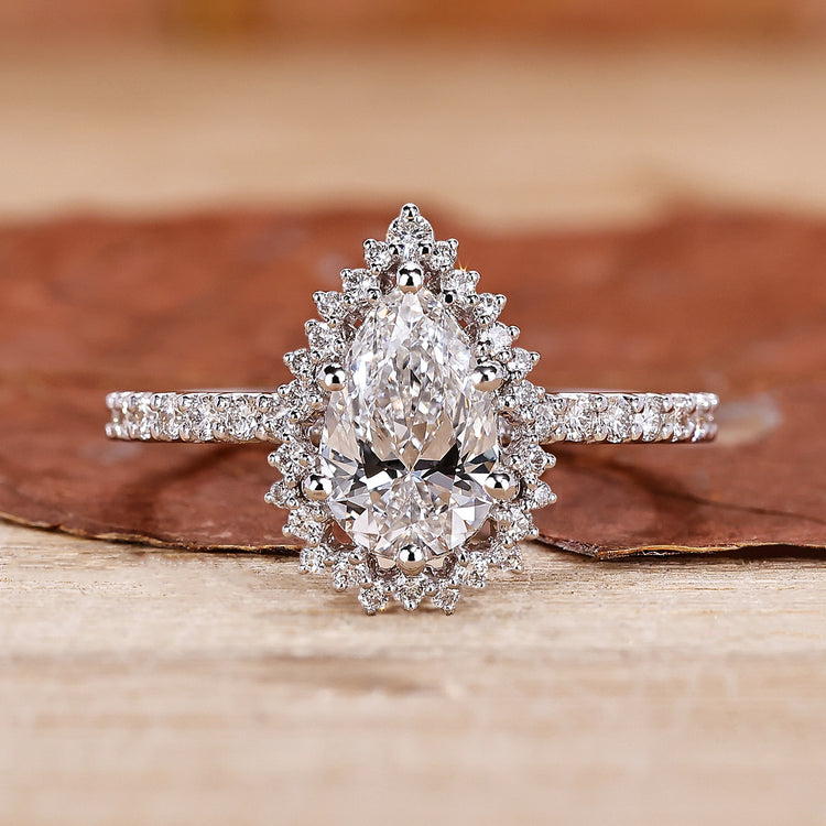 Pear cut diamond engagement ring with a sleek white gold band.
