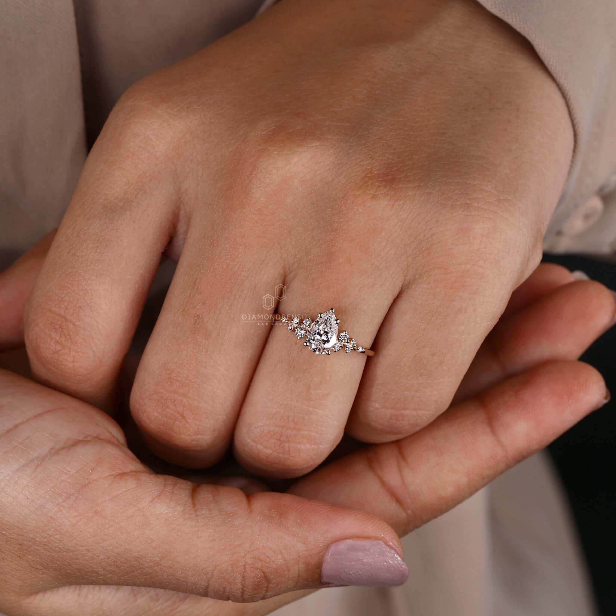 Pear shaped ring diamond paired with a 4 prong diamond ring design.
