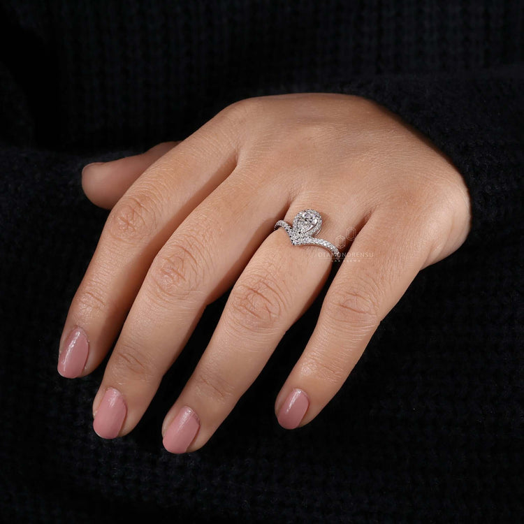 Pave band engagement ring with a pear shaped diamond, perfect for adding glamour to any special occasion.
