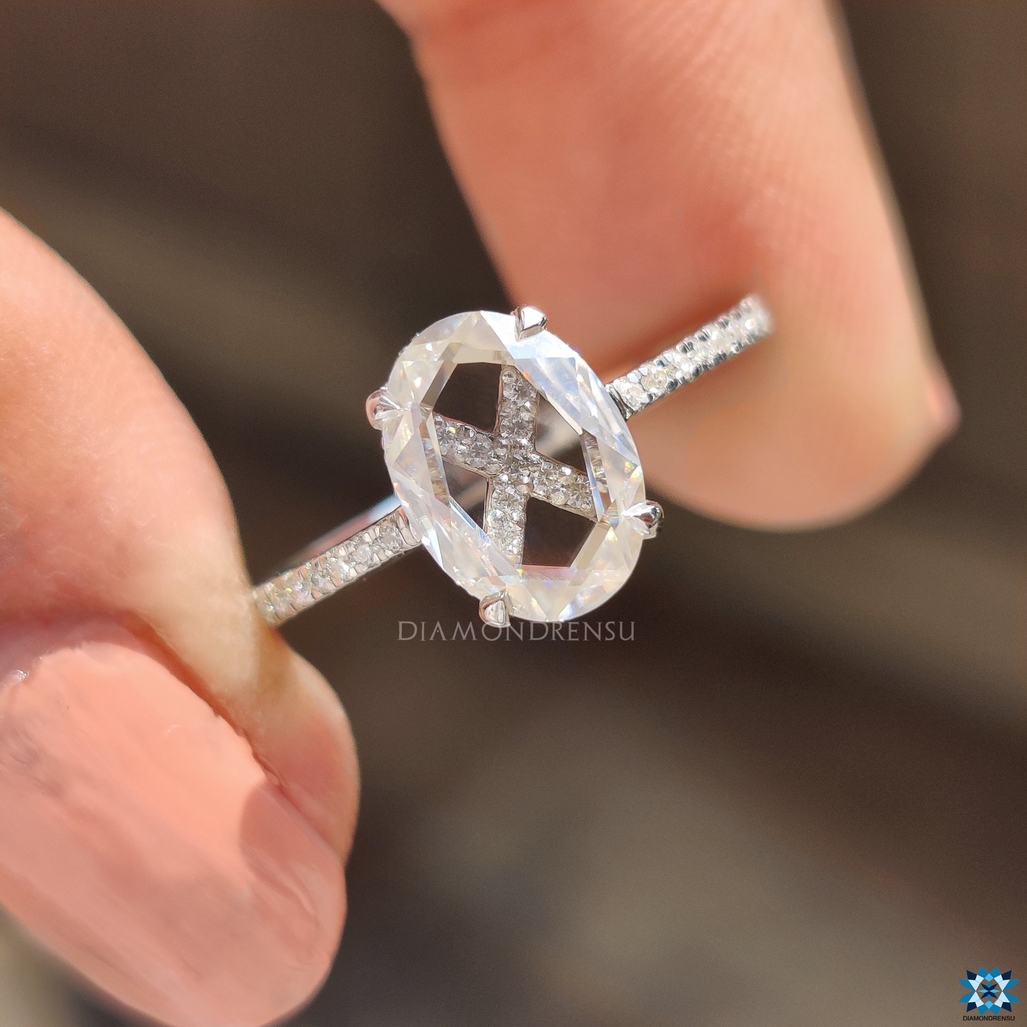 Diamondrensu UK engagement ring with oval rose cut and round pave stones.
