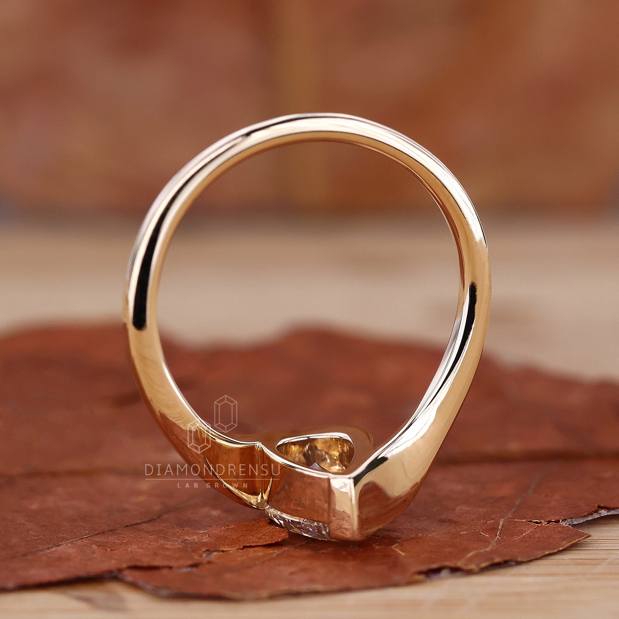 Handcrafted pear shaped engagement ring on model’s hand