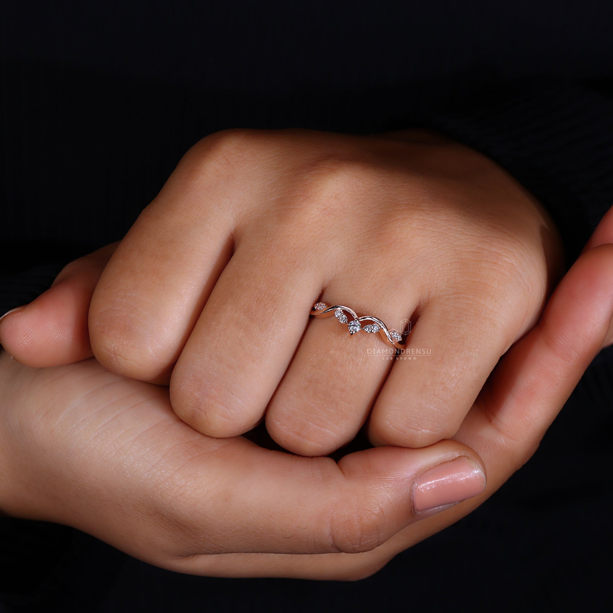 Rose gold curved diamond wedding ring.
