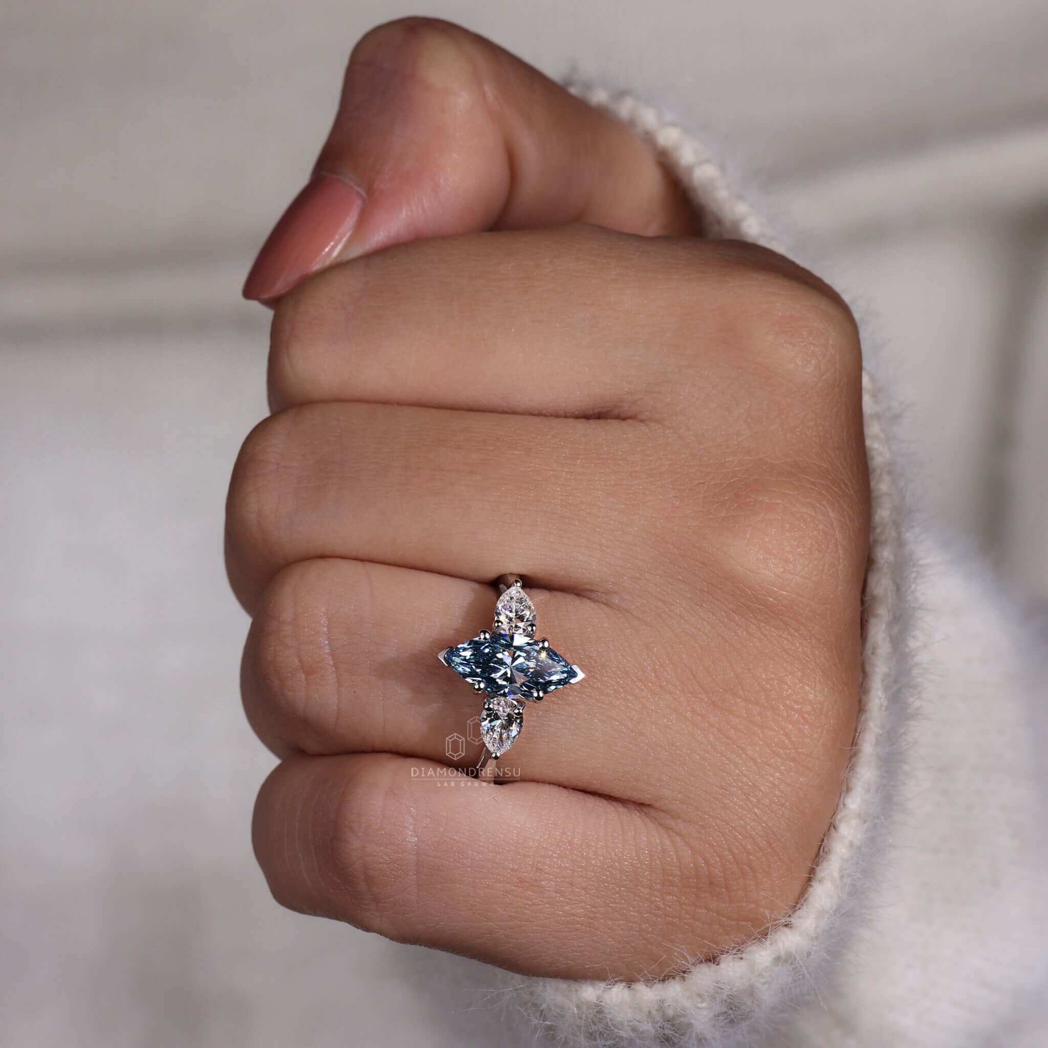 Pear shaped ring with a stunning blue marquise diamond.