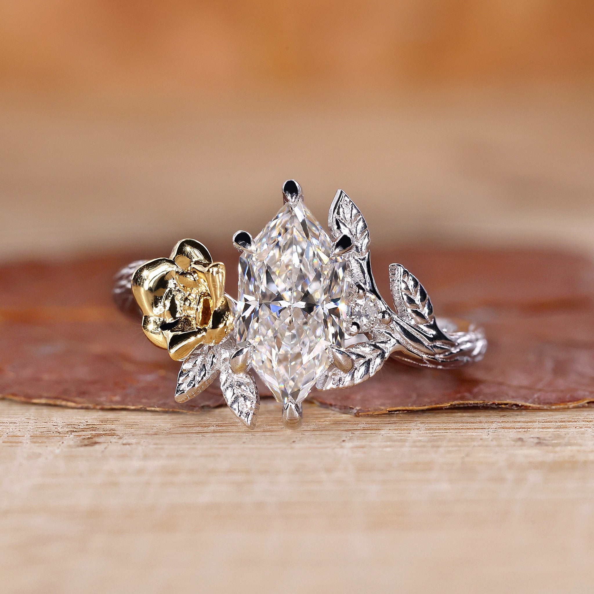Dutch marquise diamond engagement ring with round side diamond and six claw prong set.
