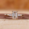 3 stone emerald cut diamond ring in yellow gold, made for UK engagement ring buyers.
