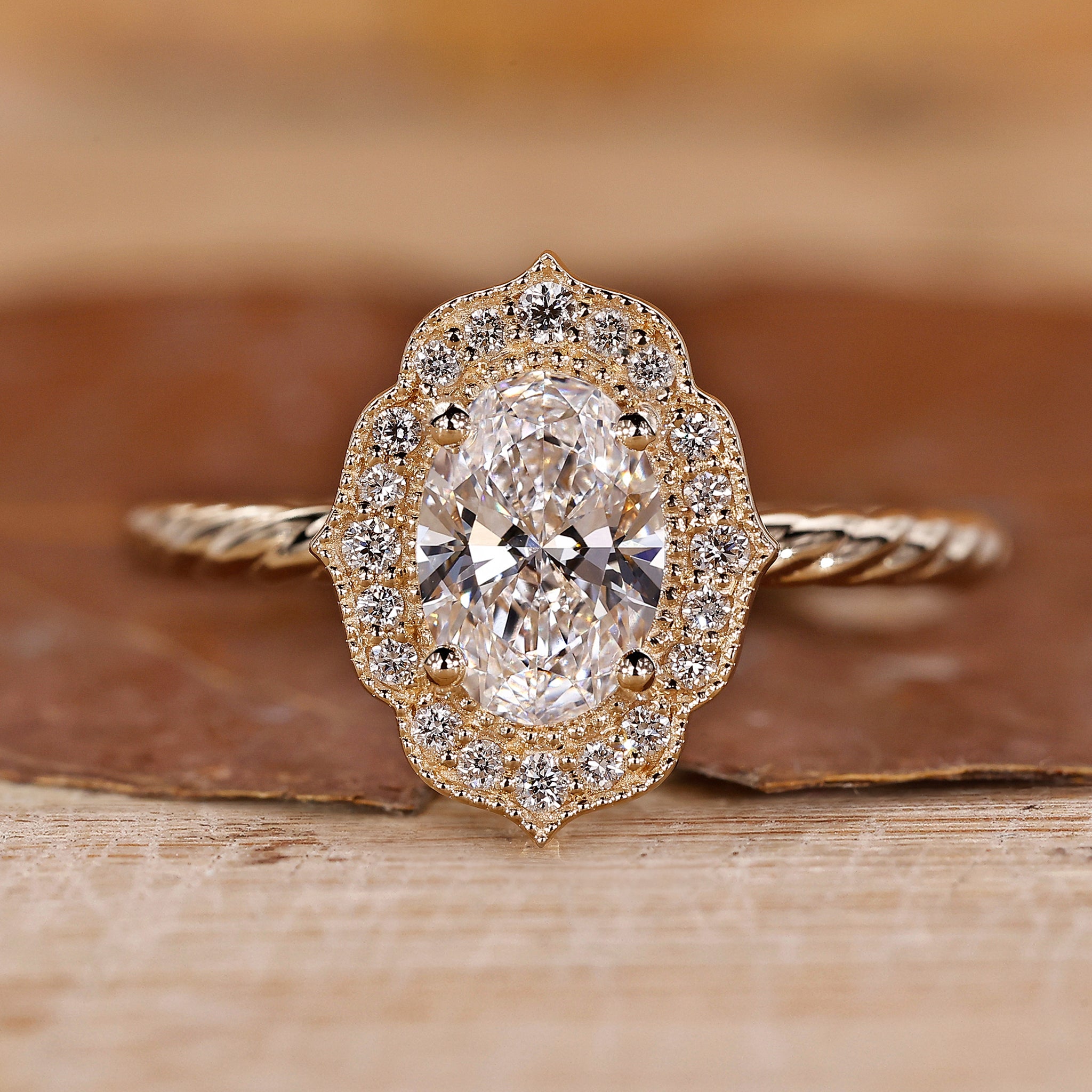 Oval Diamond Engagement Ring is made using a yellow gold ring and round diamond ring.
