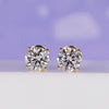 Gold stud earrings with round lab grown diamonds in 4 prong setting.