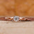 Round diamond ring with twisted shank in rose gold for UK engagement ring.
