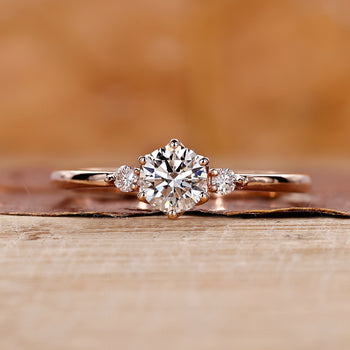 Three stone engagement ring made using rose gold ring.

