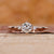 Three stone engagement ring made using rose gold ring.
