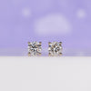 Round diamond stud earrings crafted in yellow gold with prong settings.