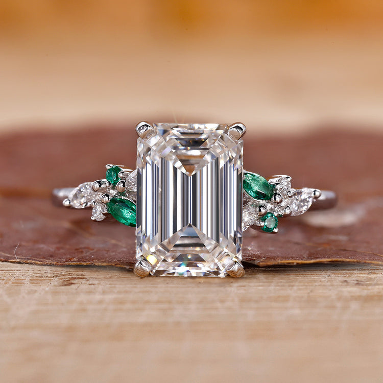 Emerald cut diamond ring with muse setting and marquise side stones.
