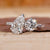 Toi et Moi diamond ring with pear and round diamonds in white gold.
