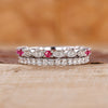 Ruby and diamond wedding band crafted with a double row pave design.

