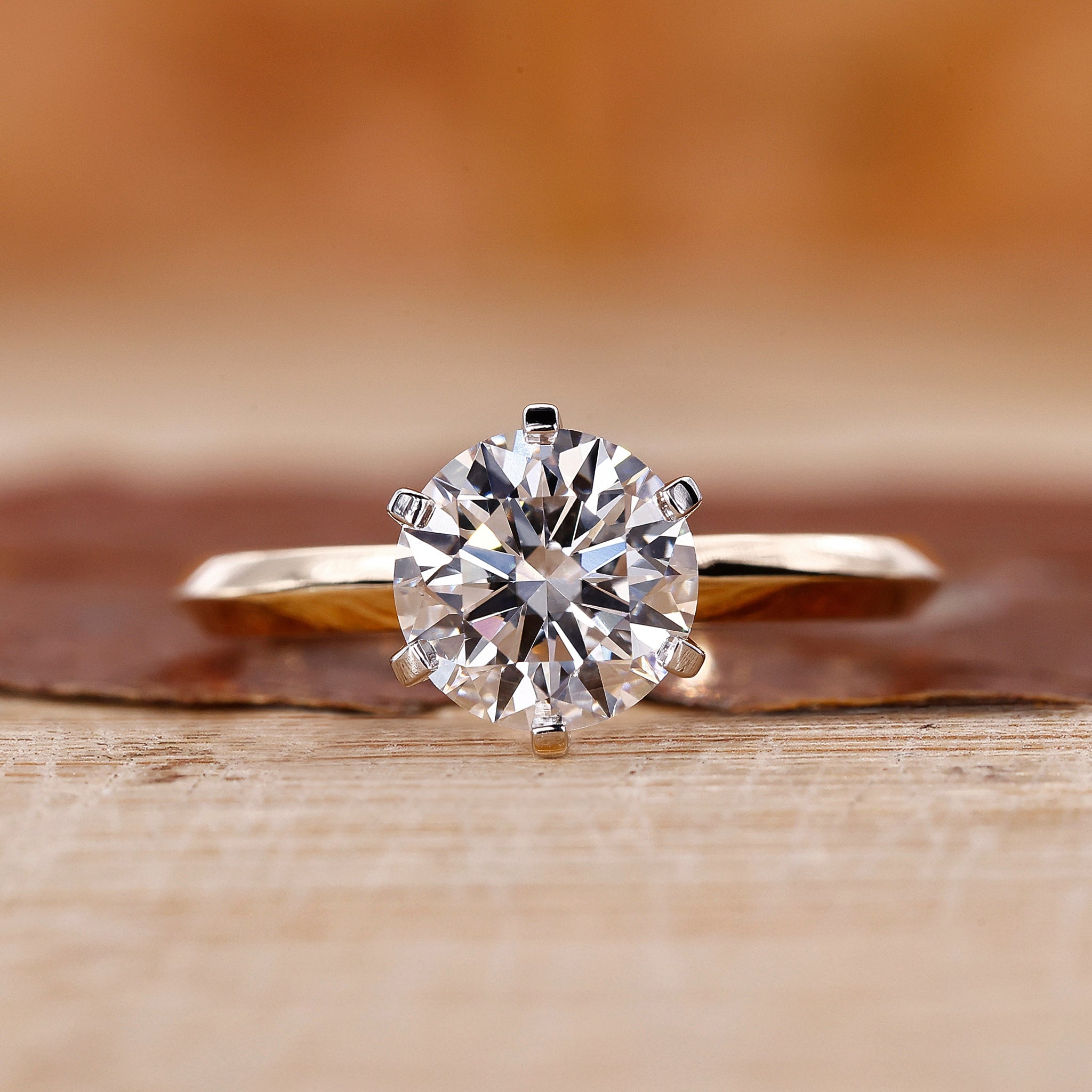 Two tone ring with round cut diamond and knife edge shank.
