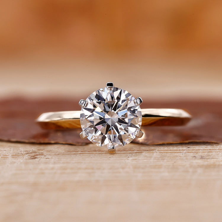 Two tone ring with round cut diamond and knife edge shank.
