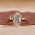Gold solitaire engagement ring with hexagon diamond.
