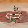 Emerald and diamond wedding band crafted in a graceful curved design.