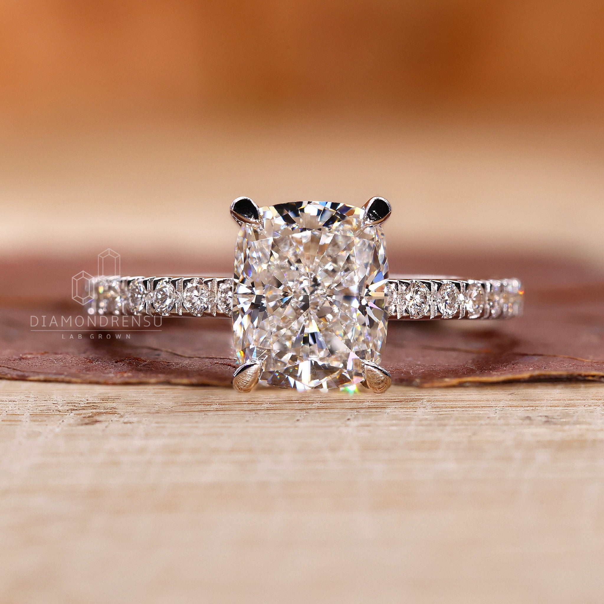 Lab diamond ring in cushion shape with hidden halo and pave band.
