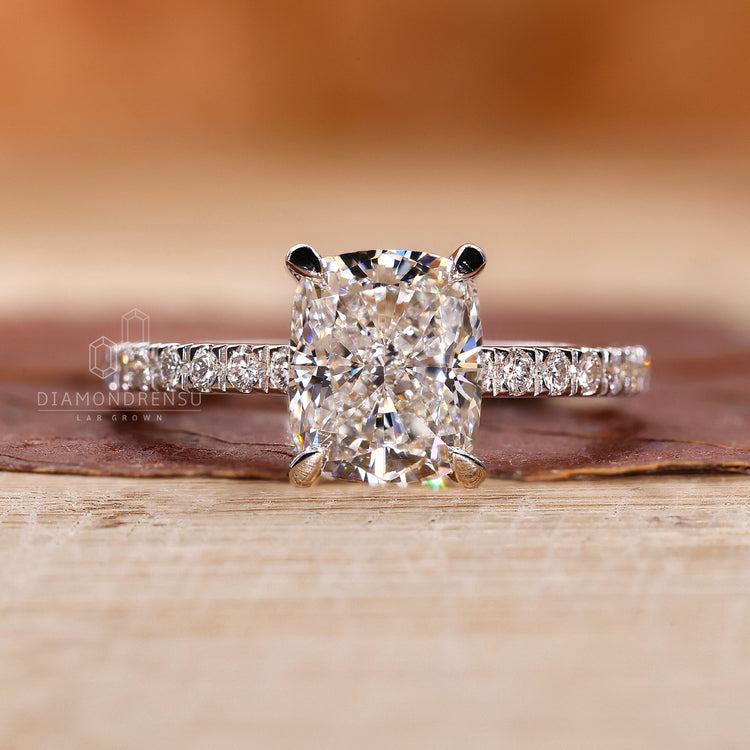 Lab diamond ring in cushion shape with hidden halo and pave band.
