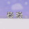 Gold stud earrings for women featuring round lab grown diamonds in 4 prong setting.