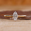 Gold marquise engagement ring with solitaire setting.
