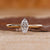 Gold marquise engagement ring with solitaire setting.
