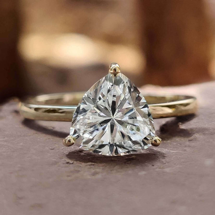 Trillion cut moissanite ring in yellow gold.
