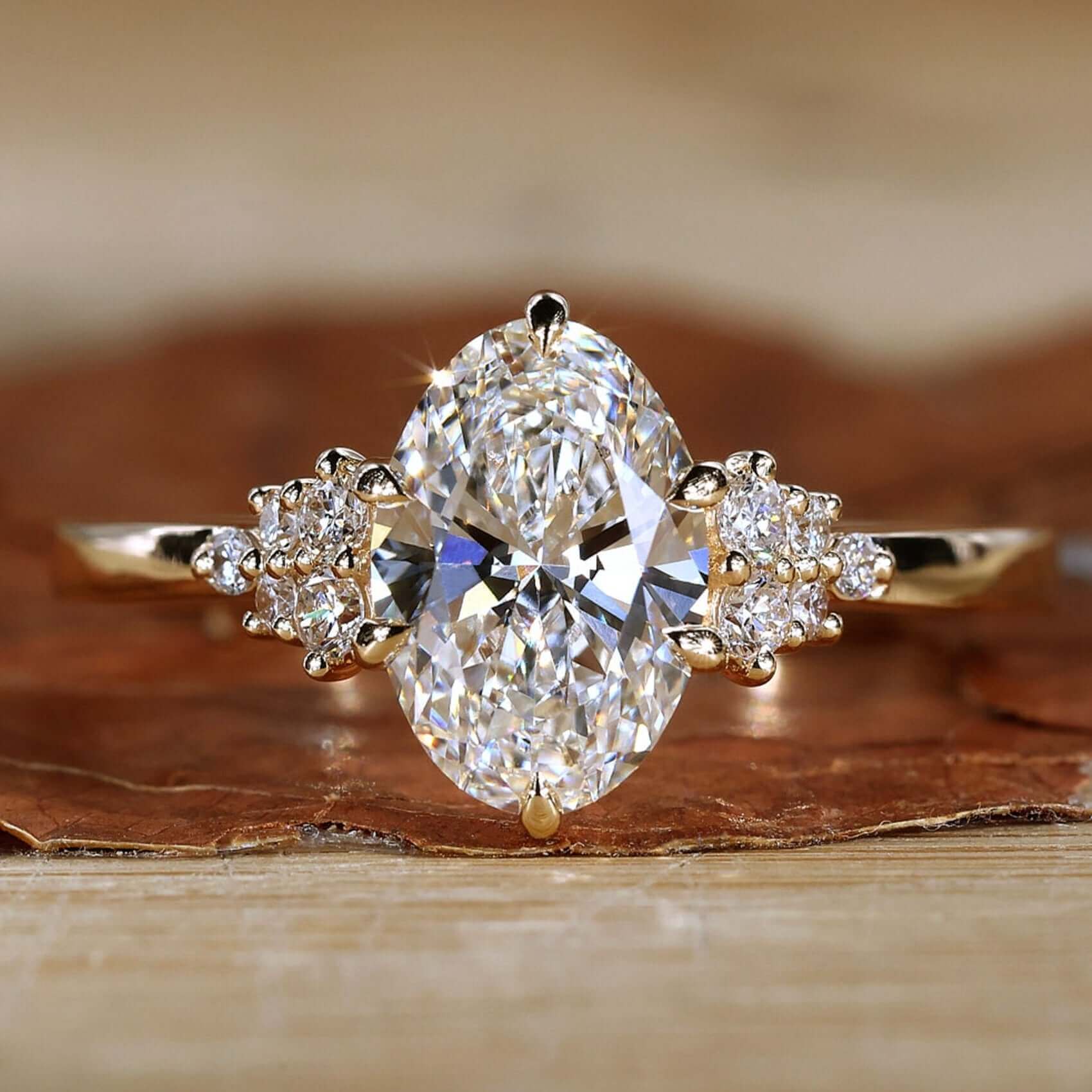 Close-up of oval diamond engagement ring on a gold band