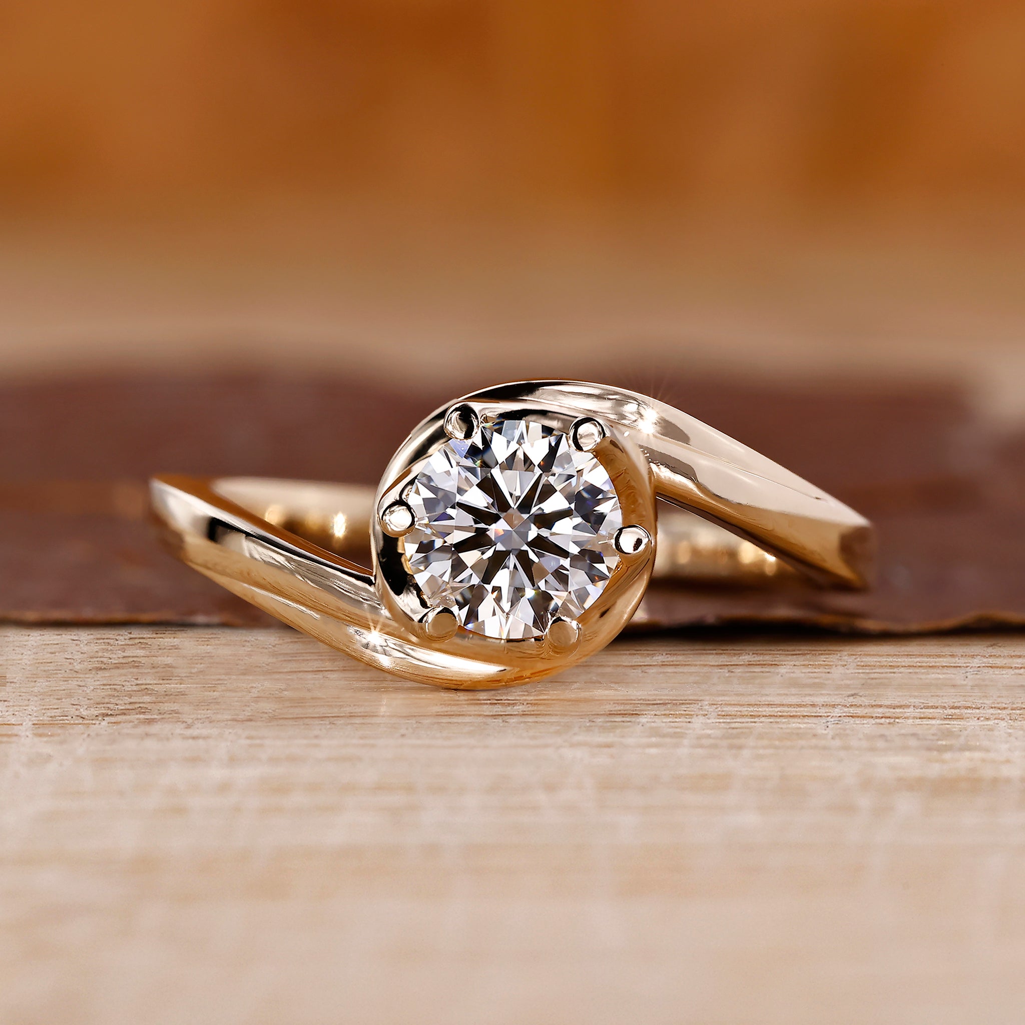 Bypass engagement ring with round diamond center stone.
