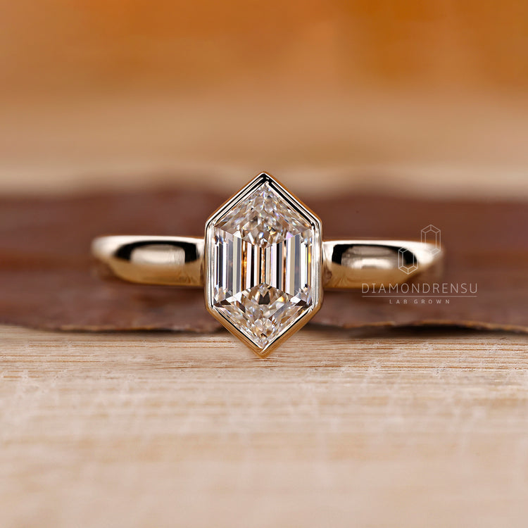Hexagon diamond ring with bezel setting.
