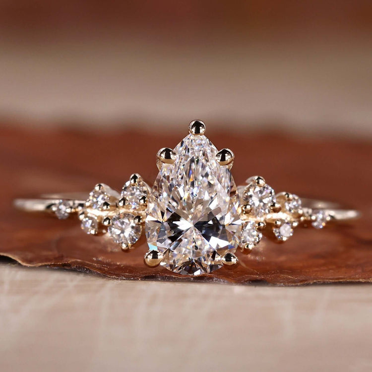 Yellow gold engagement ring featuring a pear shaped engagement ring design.

