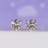 Gold diamond stud earrings with round lab grown diamonds in 4 prong setting.