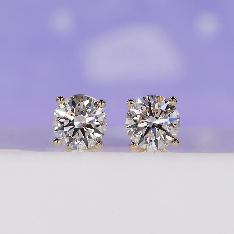 Gold diamond stud earrings with round lab grown diamonds in 4 prong setting.