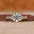 Tapered pave engagement ring with refined detailing.
