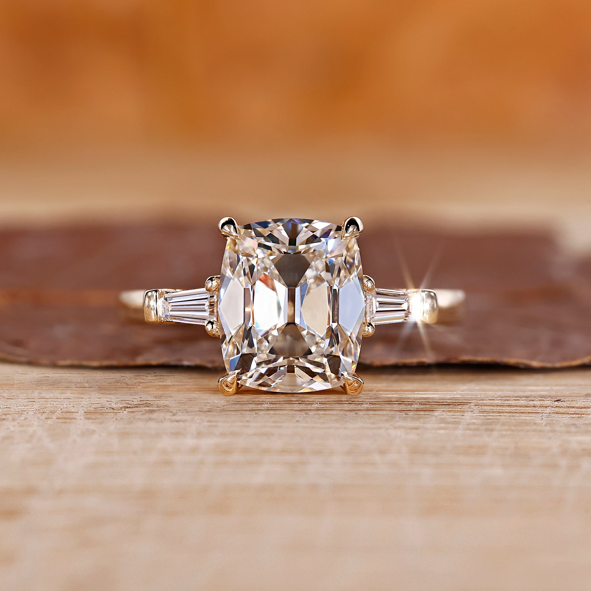 Cushion old mine cut ring with tapered baguette sides.
