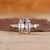 Cushion old mine cut ring with tapered baguette sides.
