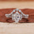 Marquise engagement ring with wedding band and round side stone.
