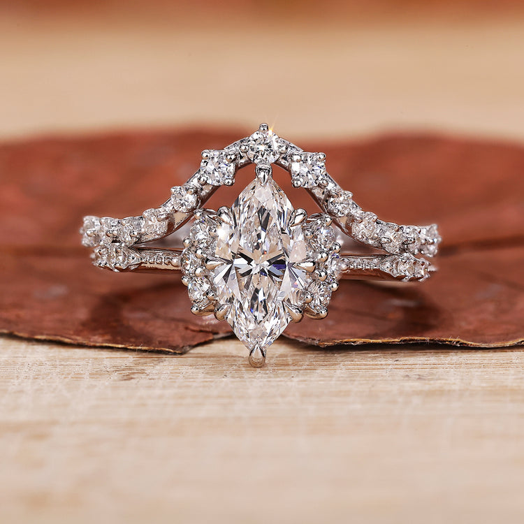 Marquise engagement ring with wedding band and round side stone.
