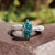 Marquise moissanite ring in white gold with V and round prong Art Deco setting.
