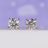Round diamond stud earrings in yellow gold.
