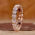 Heart shaped diamond wedding band in rose gold.
