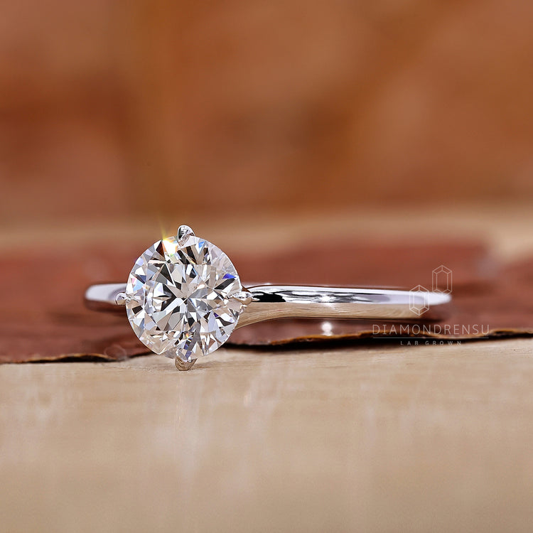 Round cut solitaire ring placed in white gold ring.
