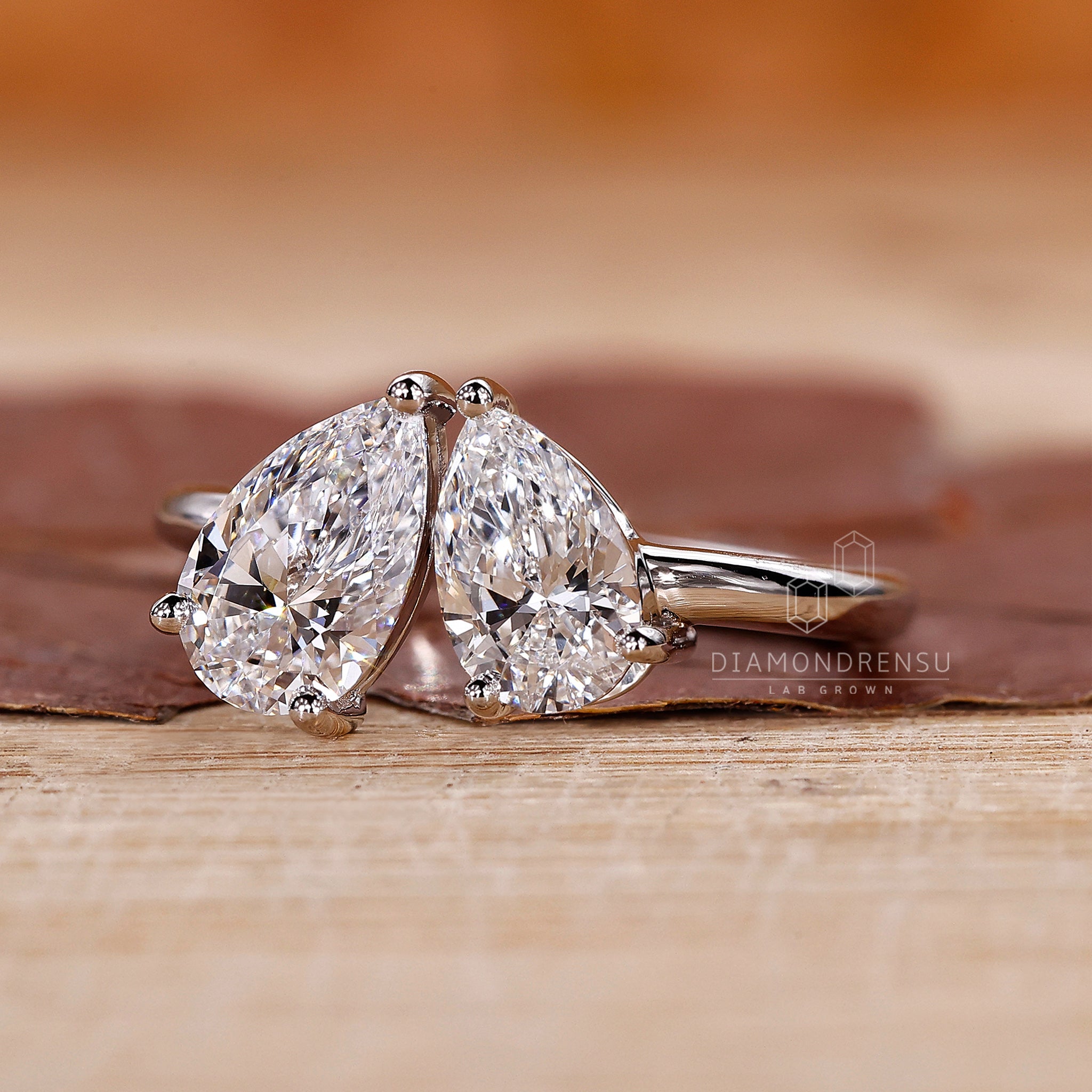 Proposal engagement ring with two pear diamond stones and white gold band.
