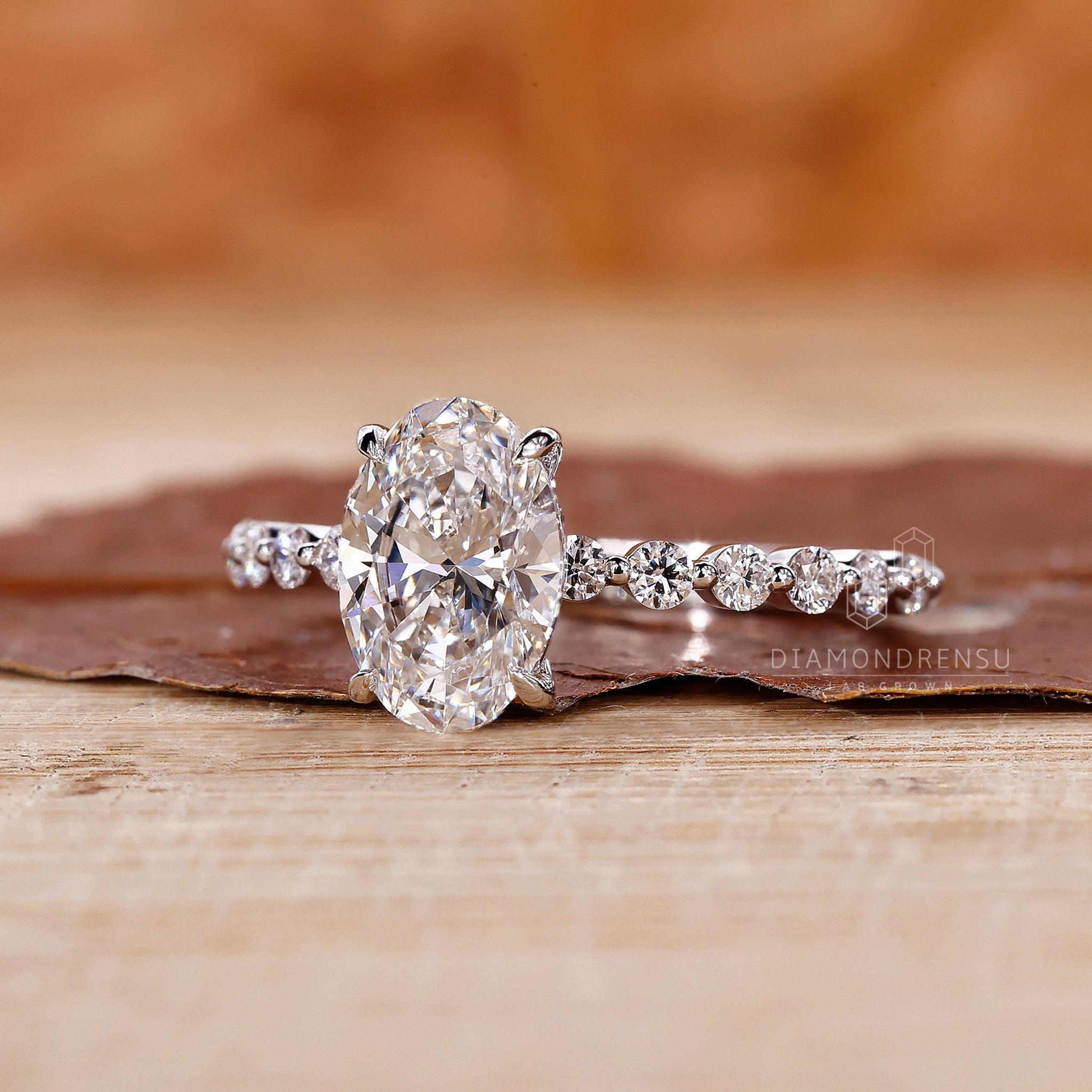 White gold engagement ring styled as oval diamond engagement ring.
